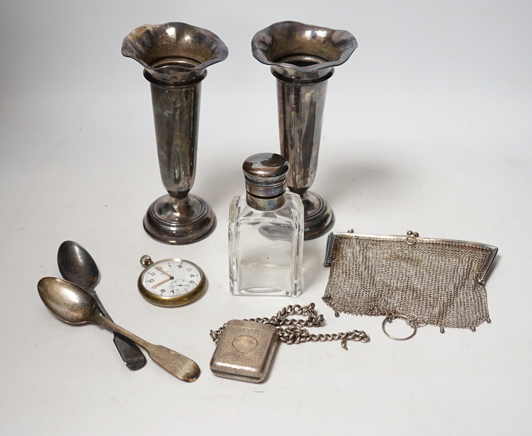 A matched pair of George V silver mounted posy vases, 16.3cm, together with a silver topped toilet jar, silver vesta case on a silver albert, a silver mesh evening bag, two silver spoons and a base metal pocket watch.